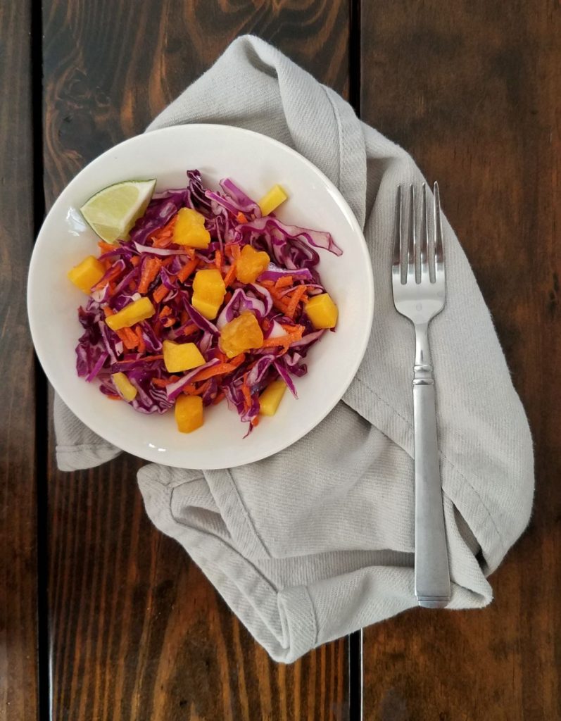 red cabbage and mango slaw in white bowl