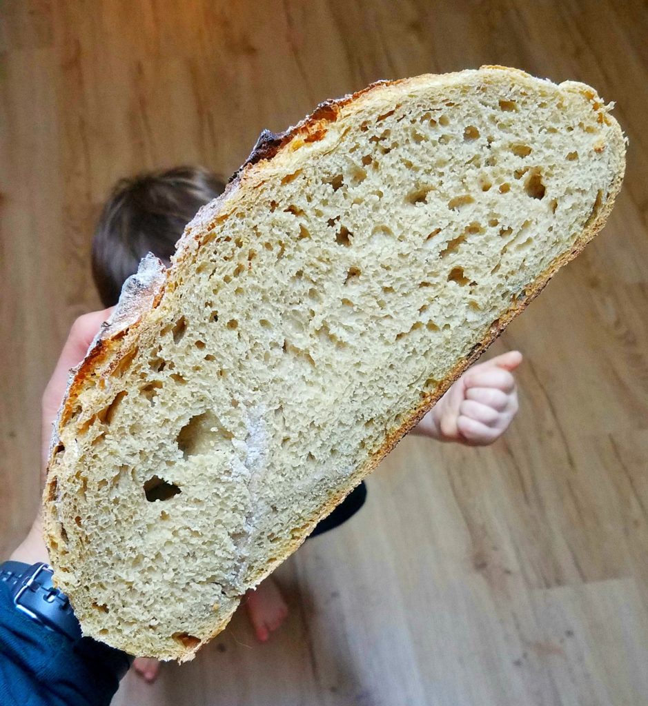 Child reaching for sourdough boule