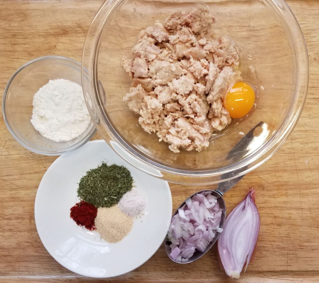 ingredients for salmon cakes in various bowls