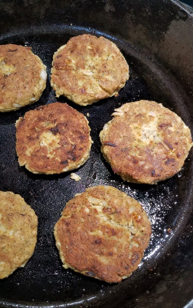 browned salmon cakes in cast iron skillet