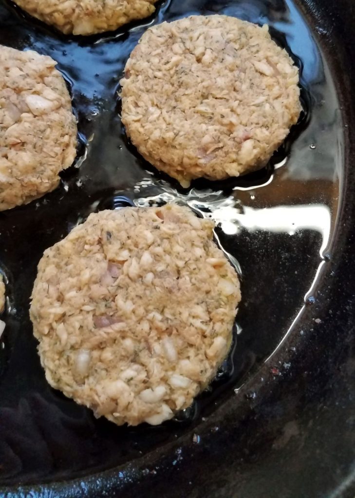 gluten-free salmon cake in cast iron skillet