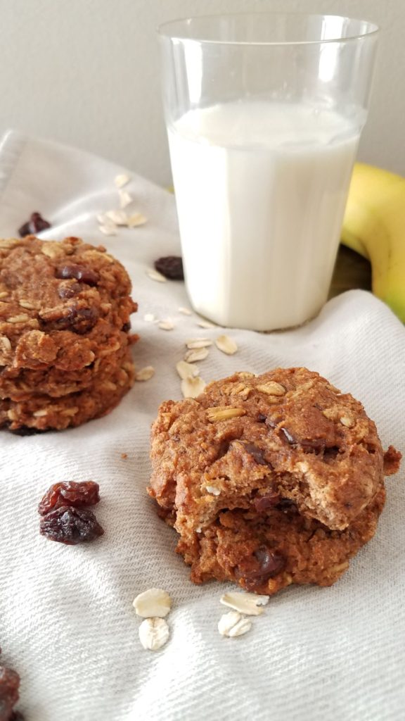 2 stacks of cookies on napkin with glass of milk