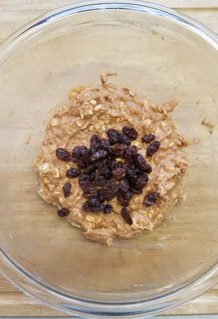 banana oatmeal batter in bowl with raisins