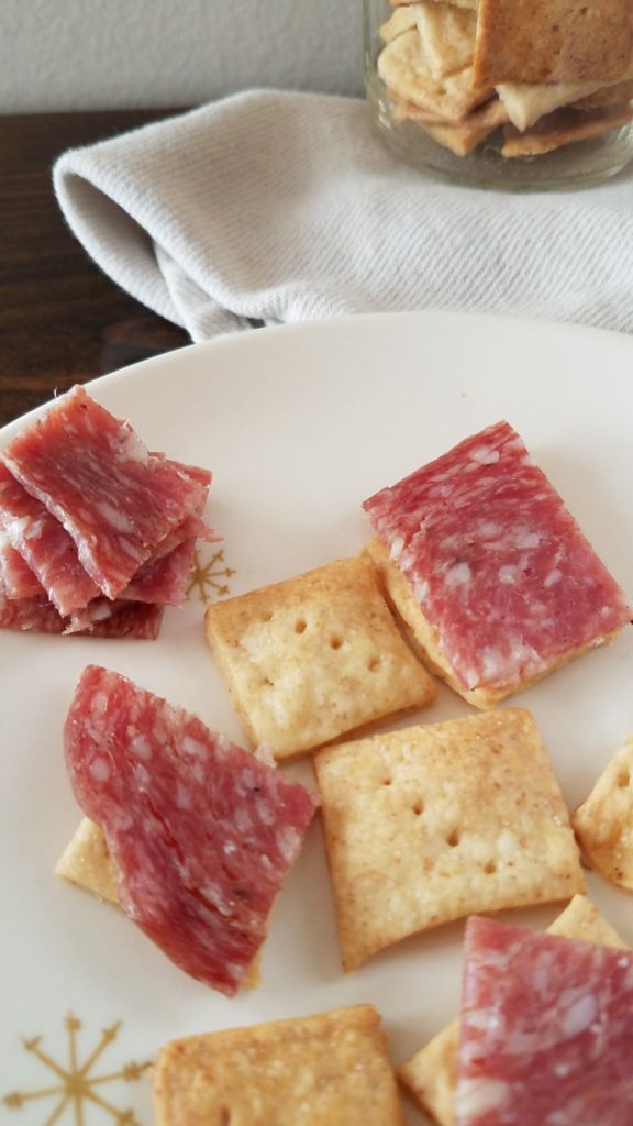 salami on sourdough cracker on plate