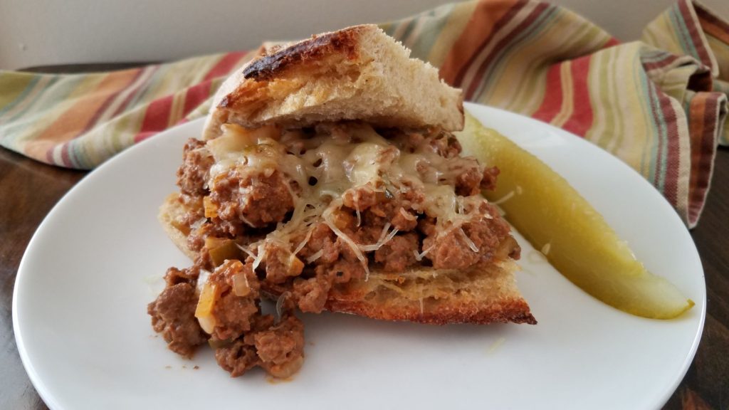 sloppy joe on plate with pickle