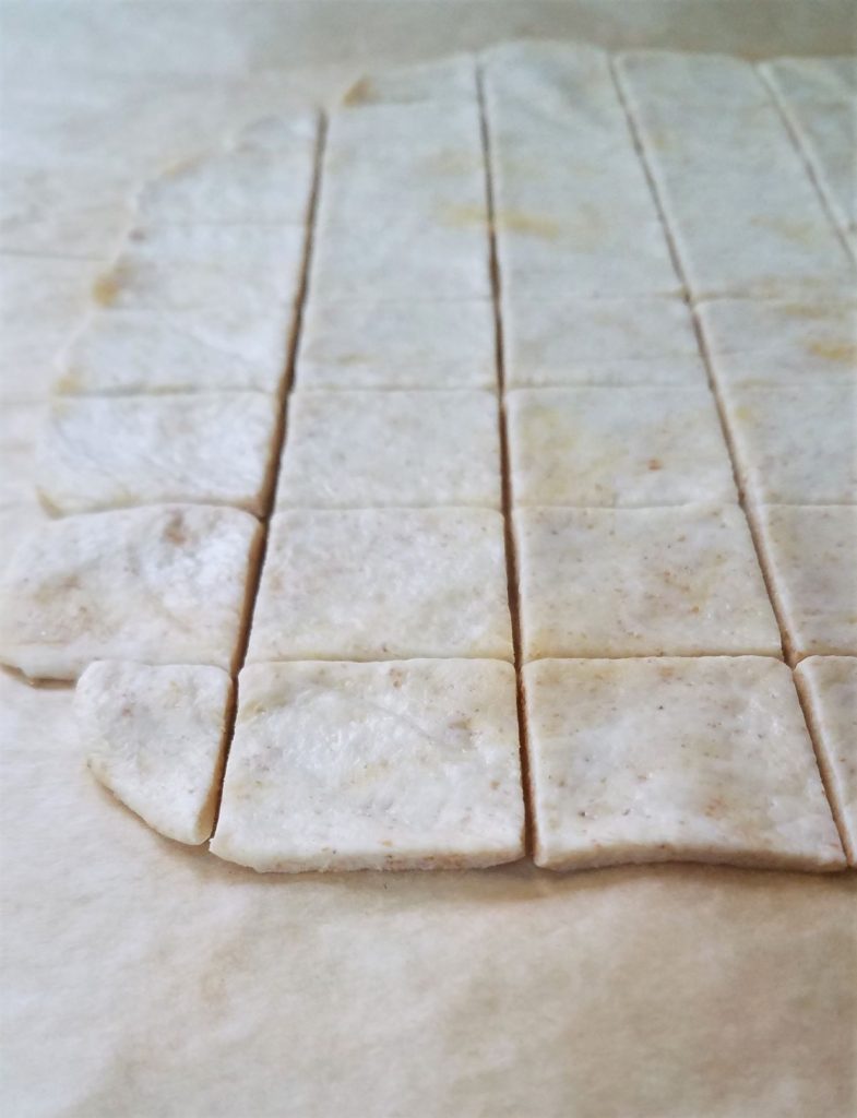 rows of sourdough cracker on parchment paper