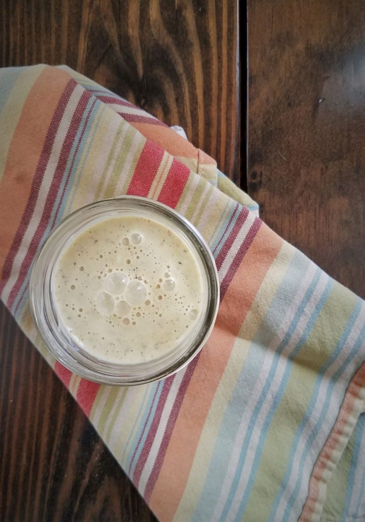 creamy coleslaw dressing in jar on striped towel
