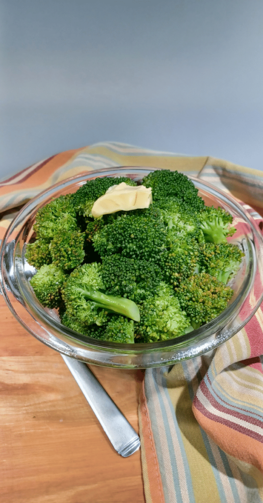 instant pot steamed vegetable in glass bowl with butter on top