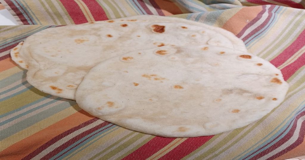 sourdough tortilla laying on striped towel