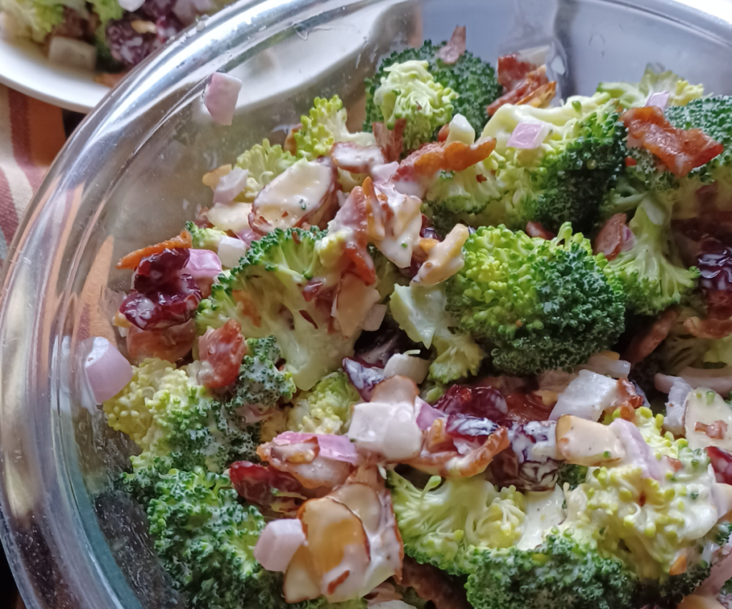 Healthy broccoli salad with cranberries in glass bowl