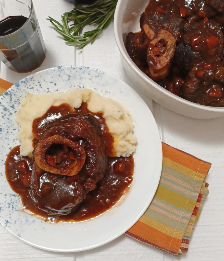 Serving dish and plate with braised braised beef osso buco