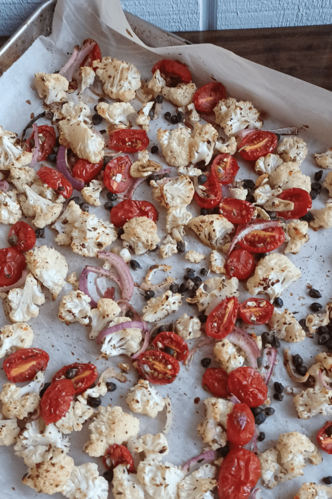 oven roasted cauliflower on a sheet pan lined with parchment paper