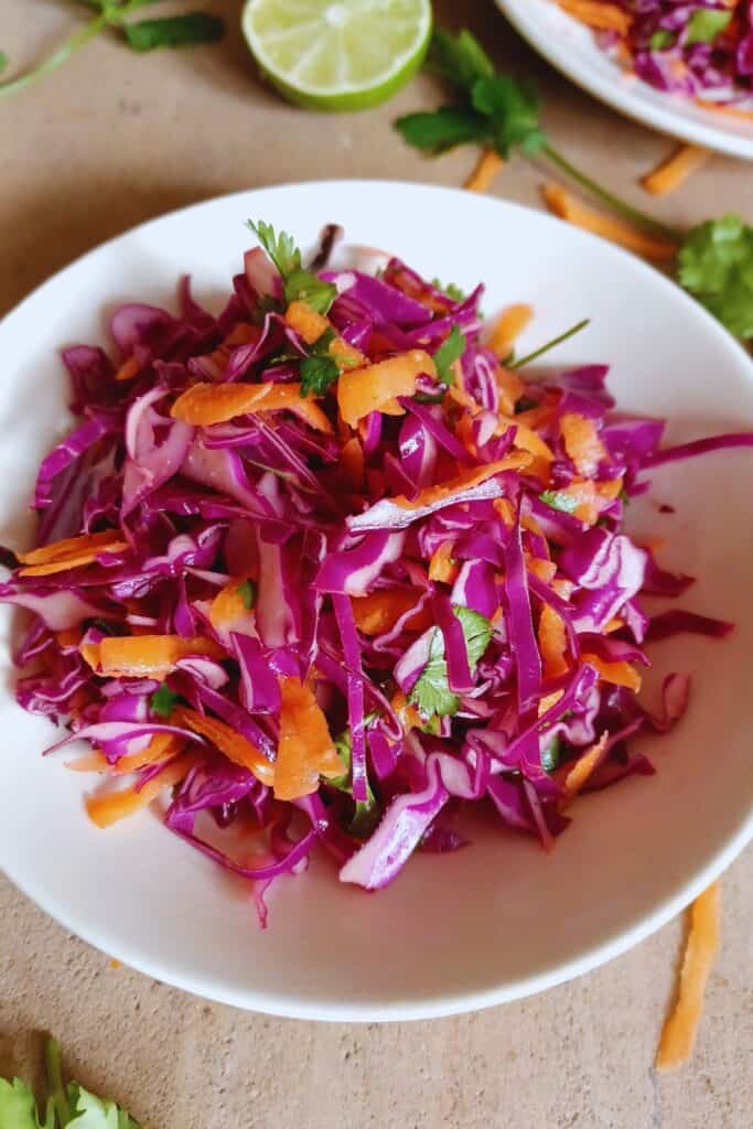 Cilantro lime slaw in a white bowl