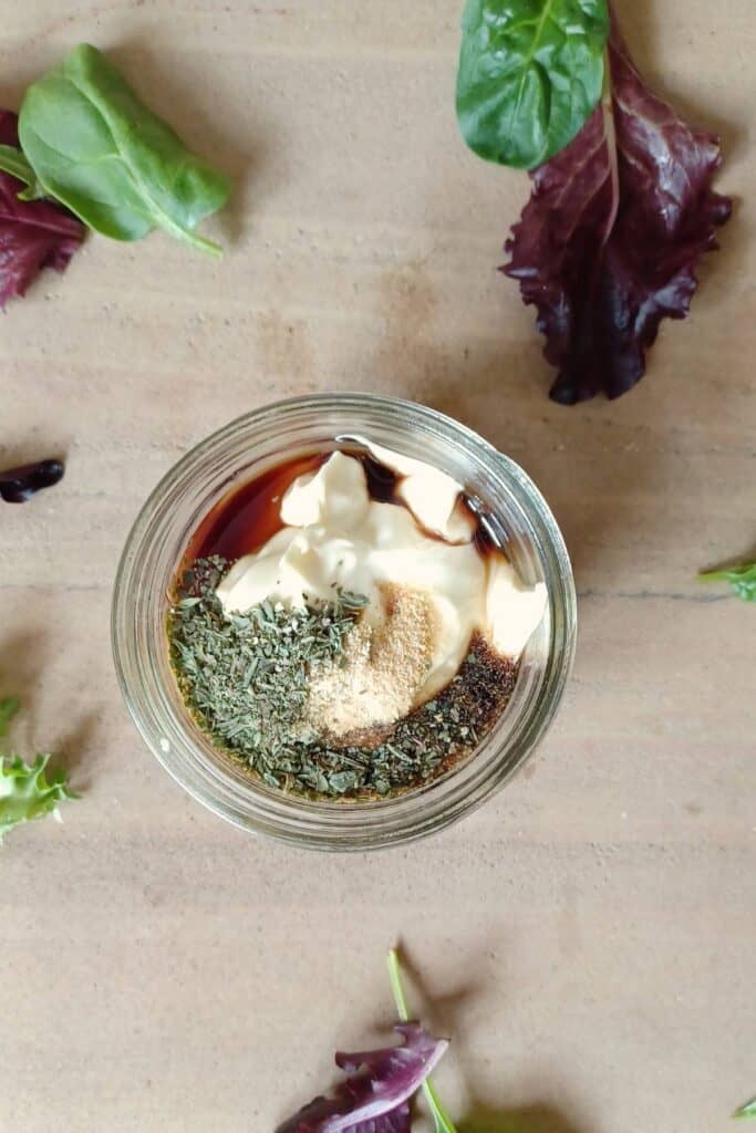 Ingredients for creamy Italian dressing in mason jar